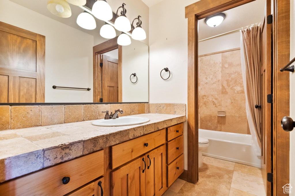 Bathroom featuring vanity, toilet, and shower / bath combo