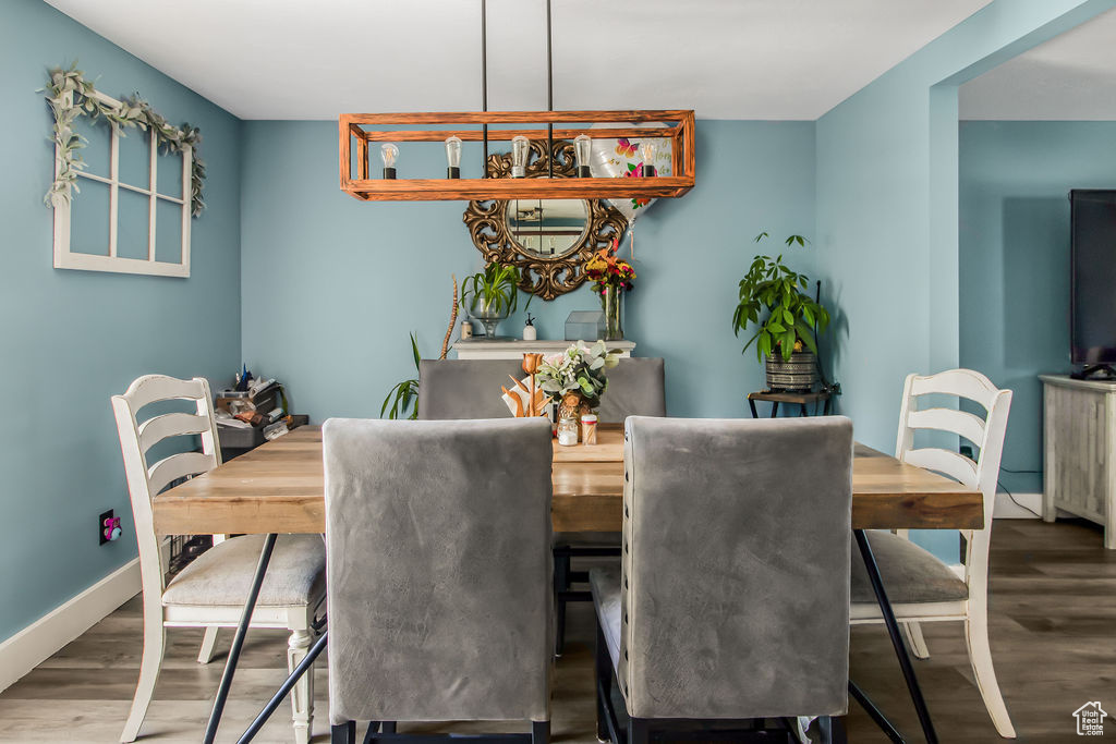 Dining space featuring wood finished floors and baseboards