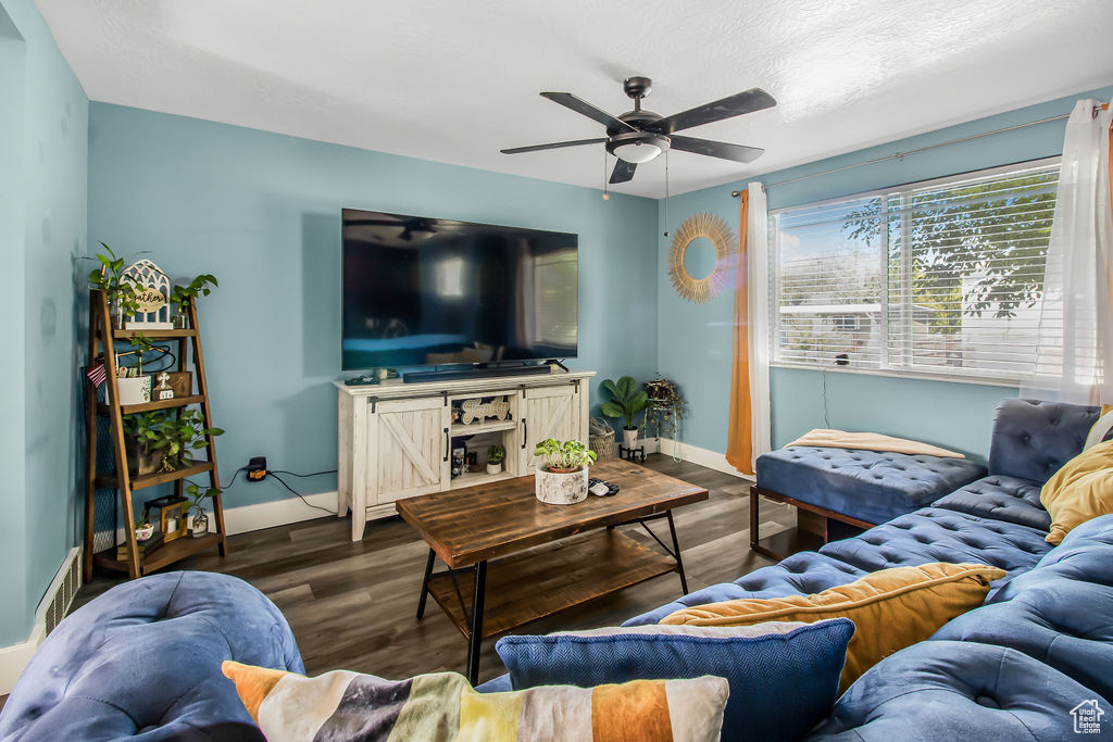 Living room featuring ceiling fan, baseboards, and wood finished floors