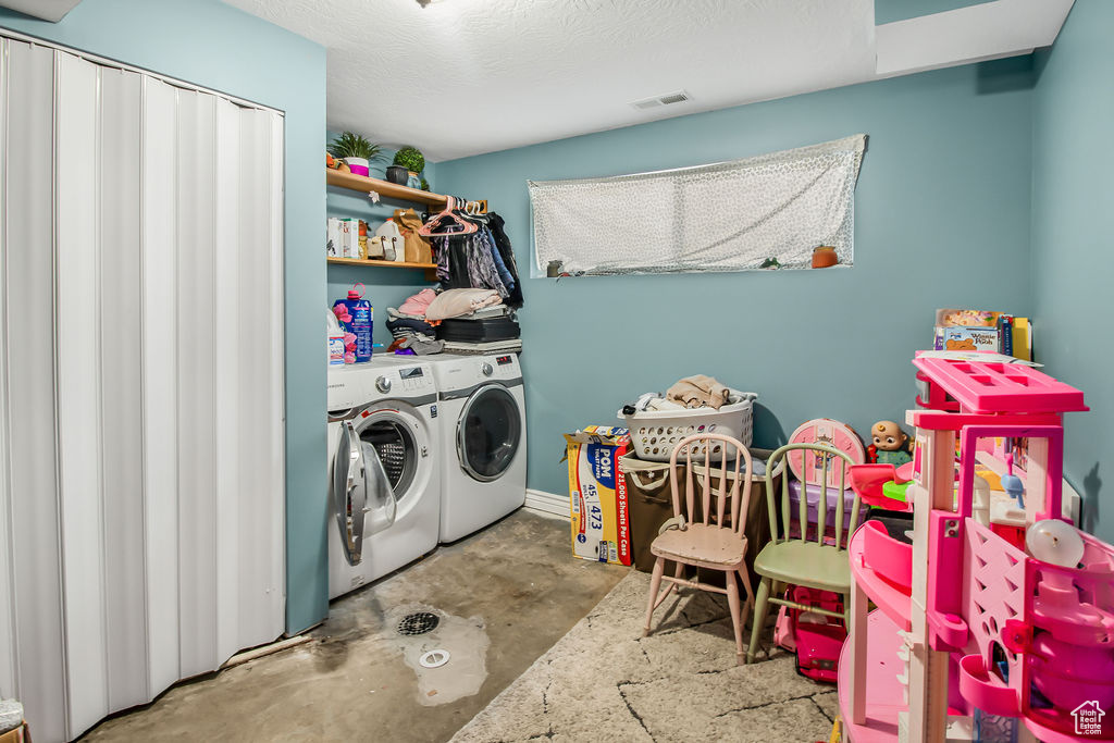 Laundry area with washer and clothes dryer