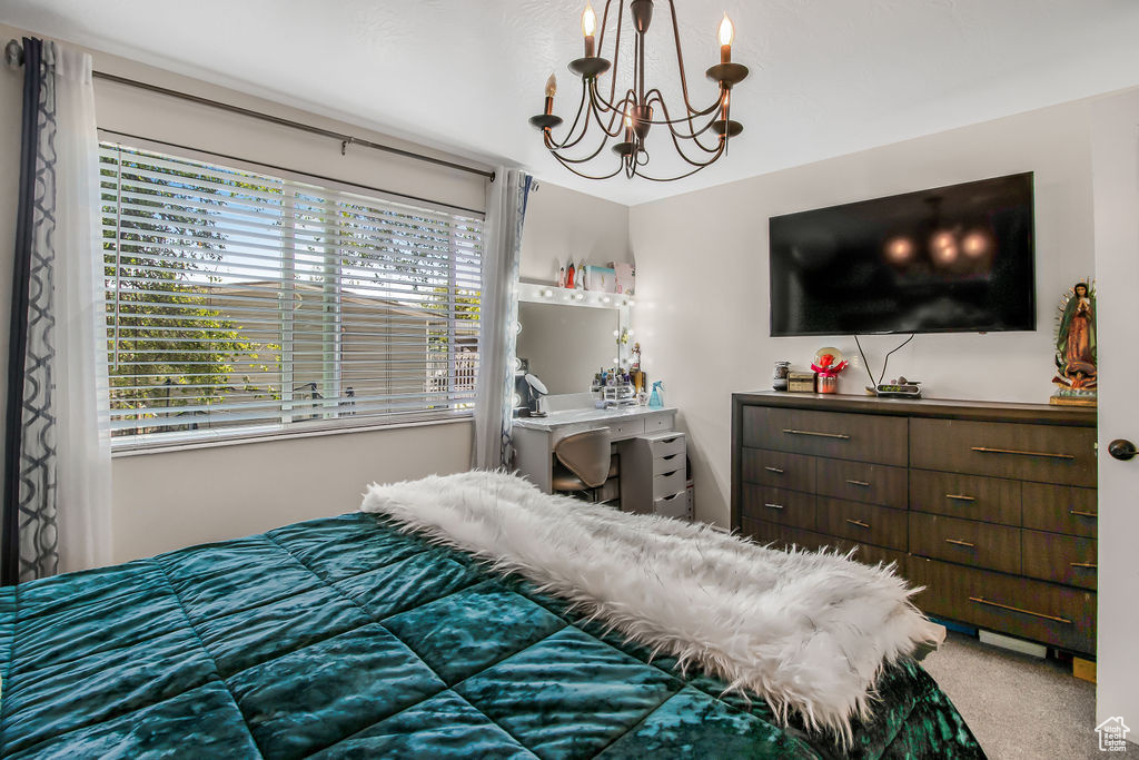 Bedroom featuring a chandelier and carpet flooring