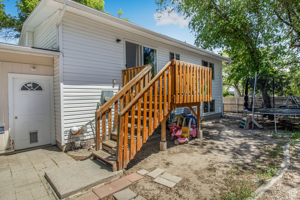 Doorway to property featuring a wooden deck