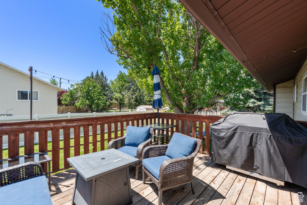 Wooden deck featuring a grill
