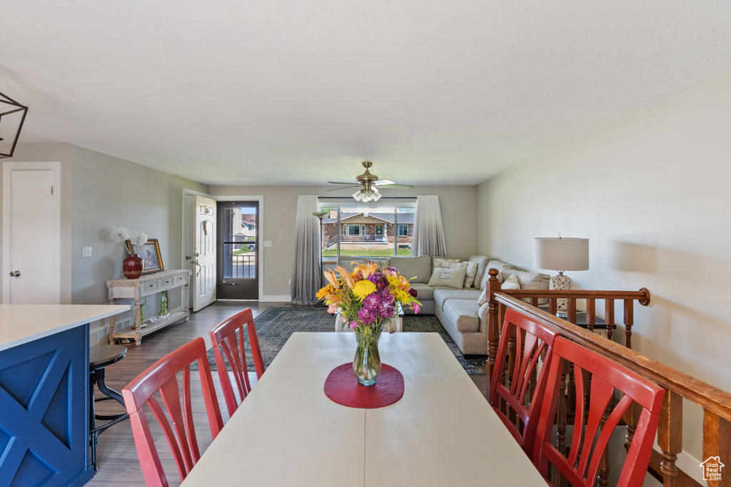 Dining area featuring dark wood-type flooring and a ceiling fan