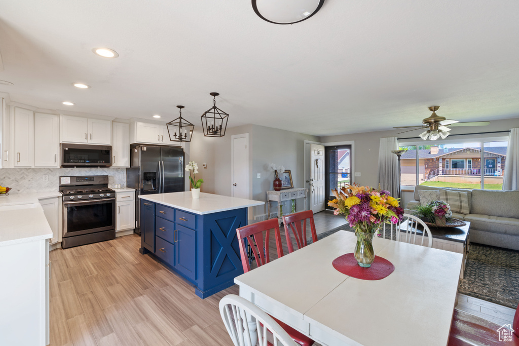 Dining space with light wood finished floors, recessed lighting, and ceiling fan