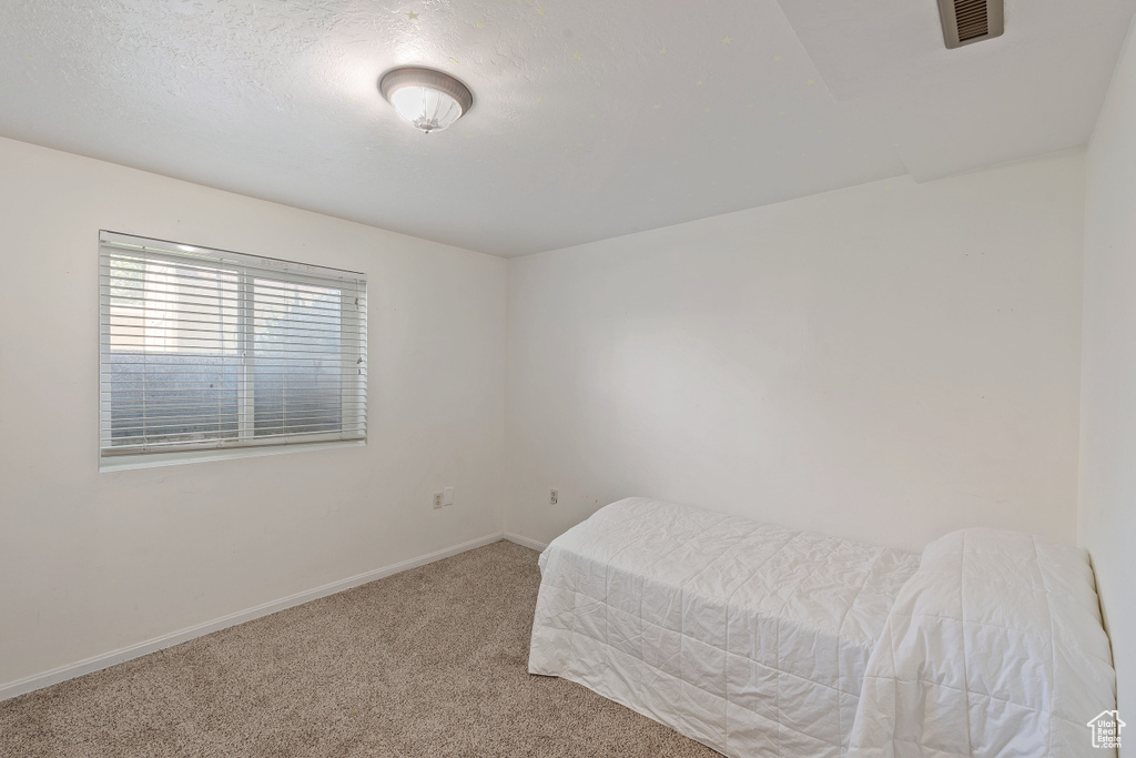 Carpeted bedroom with baseboards