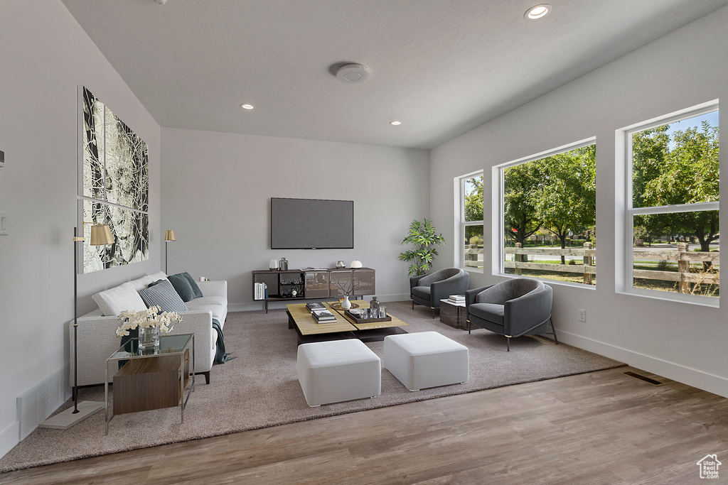 Living area featuring wood finished floors, recessed lighting, and baseboards