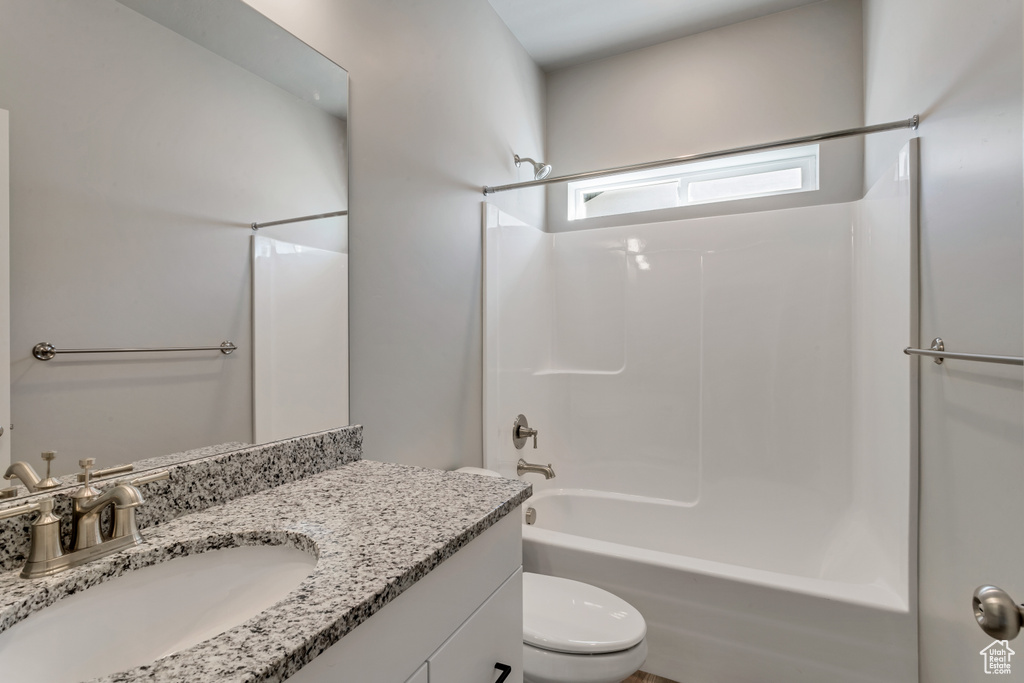Full bathroom with vanity, toilet, and shower / washtub combination