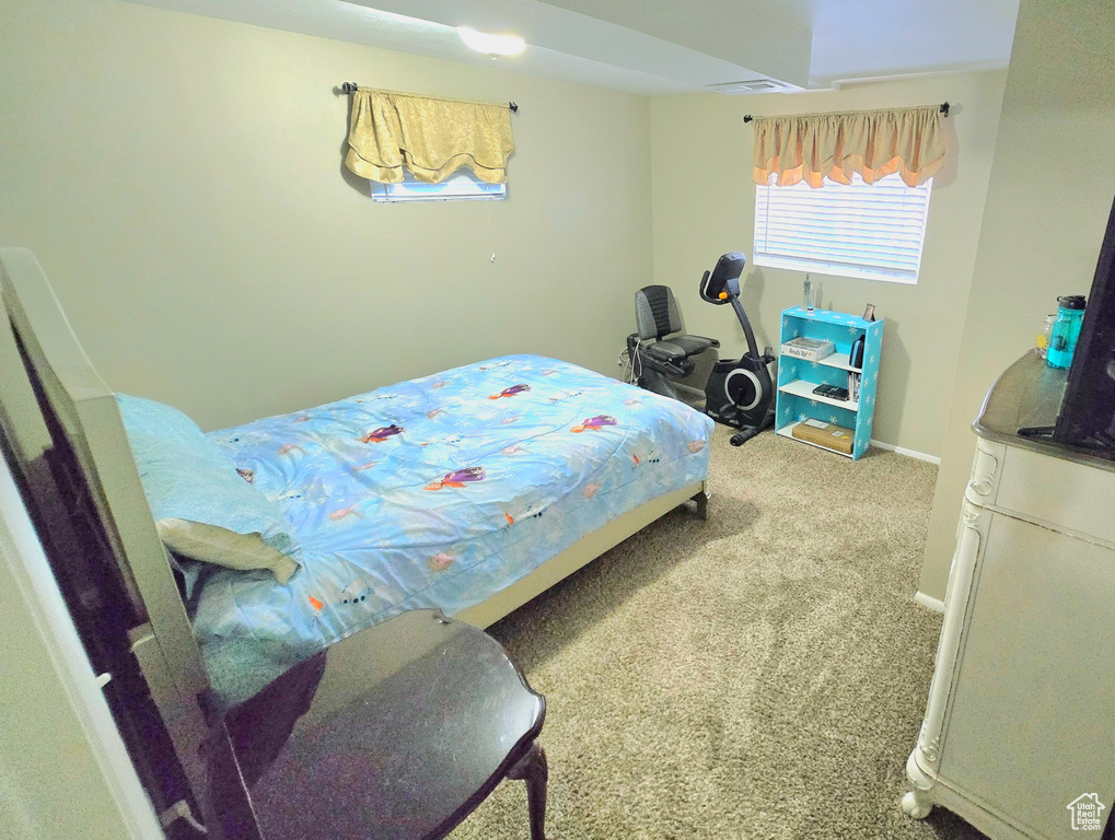 Carpeted bedroom featuring baseboards