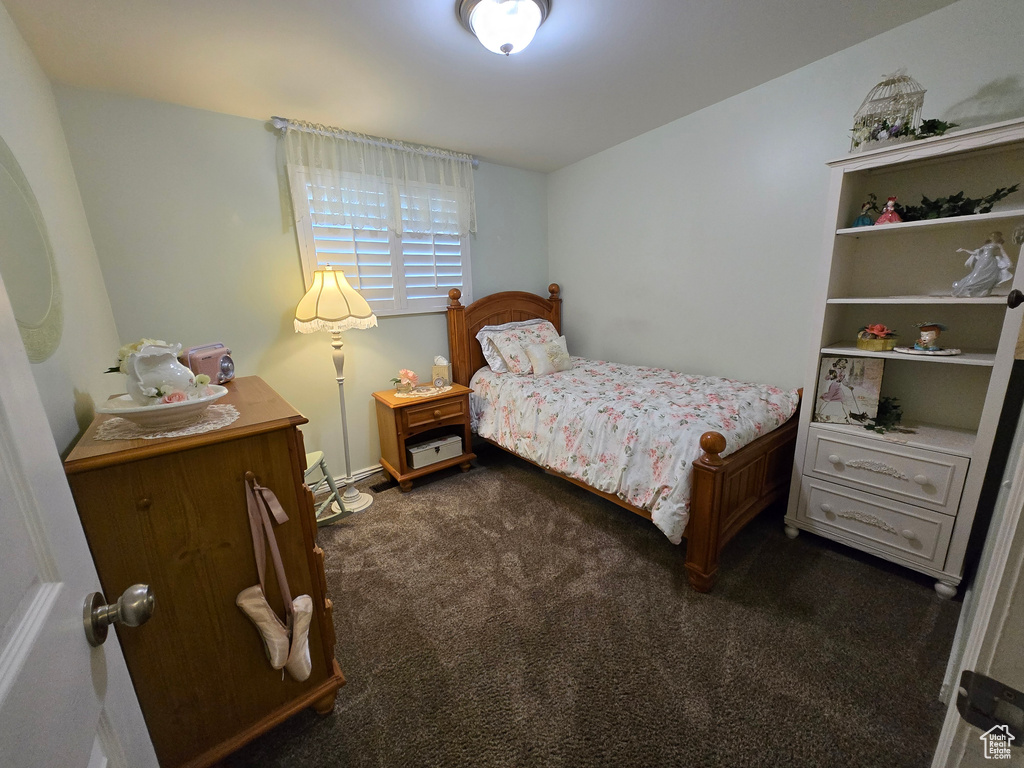 Bedroom featuring dark colored carpet