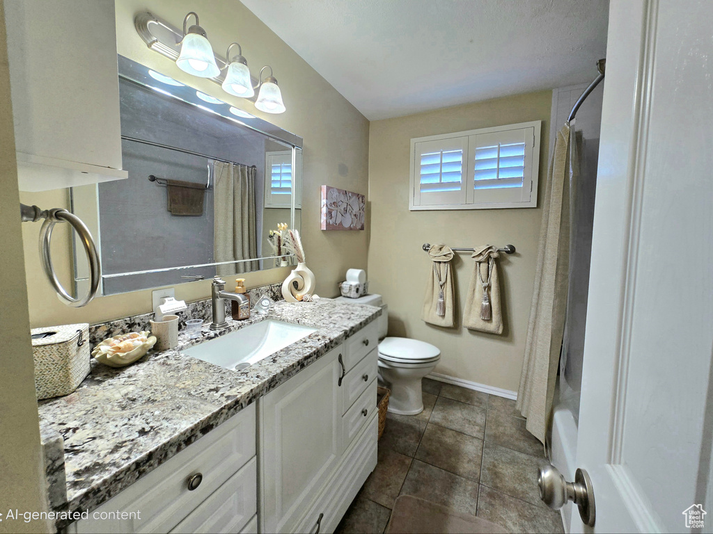 Full bathroom with vanity, healthy amount of natural light, baseboards, and toilet