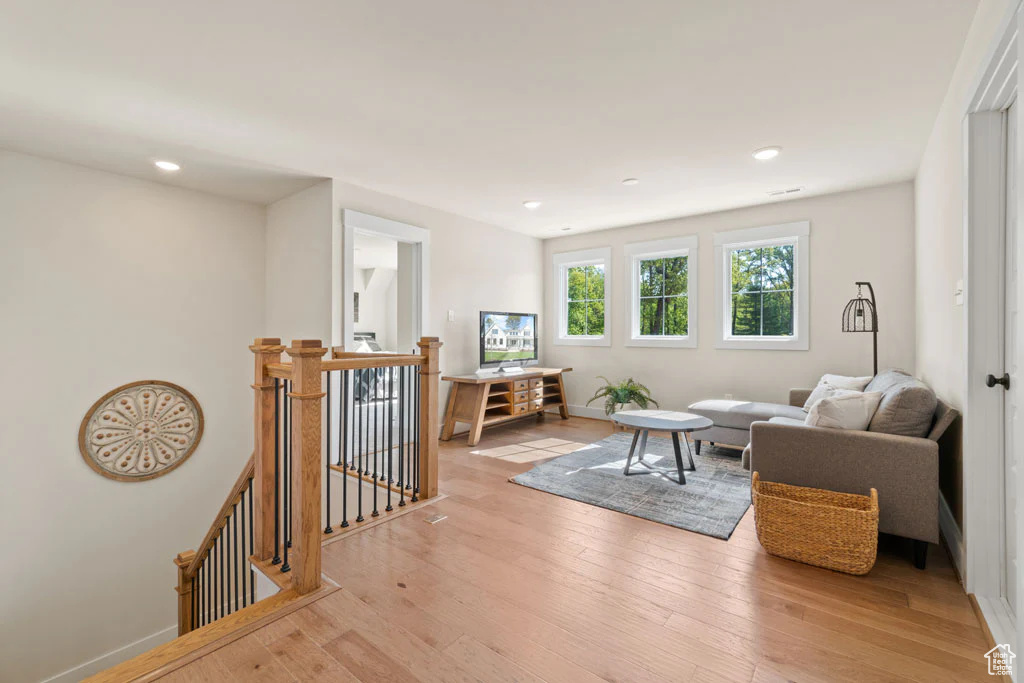Living area featuring light wood-style floors, recessed lighting, and baseboards