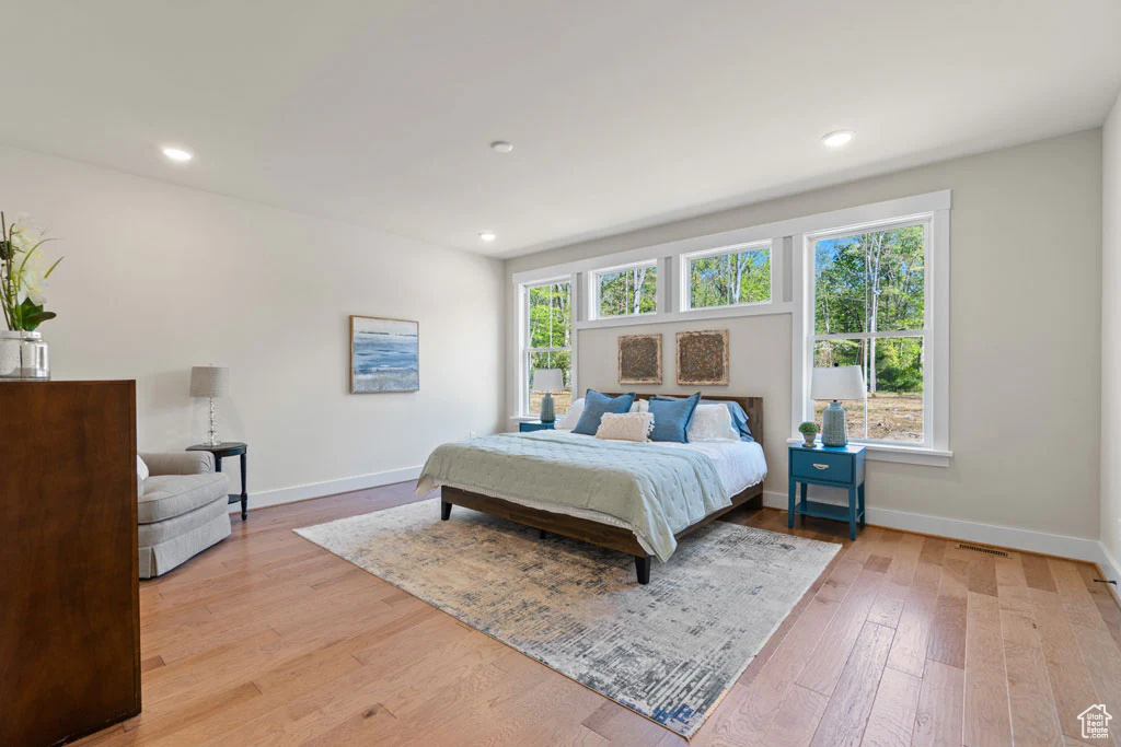 Bedroom featuring baseboards, light wood-style floors, and recessed lighting