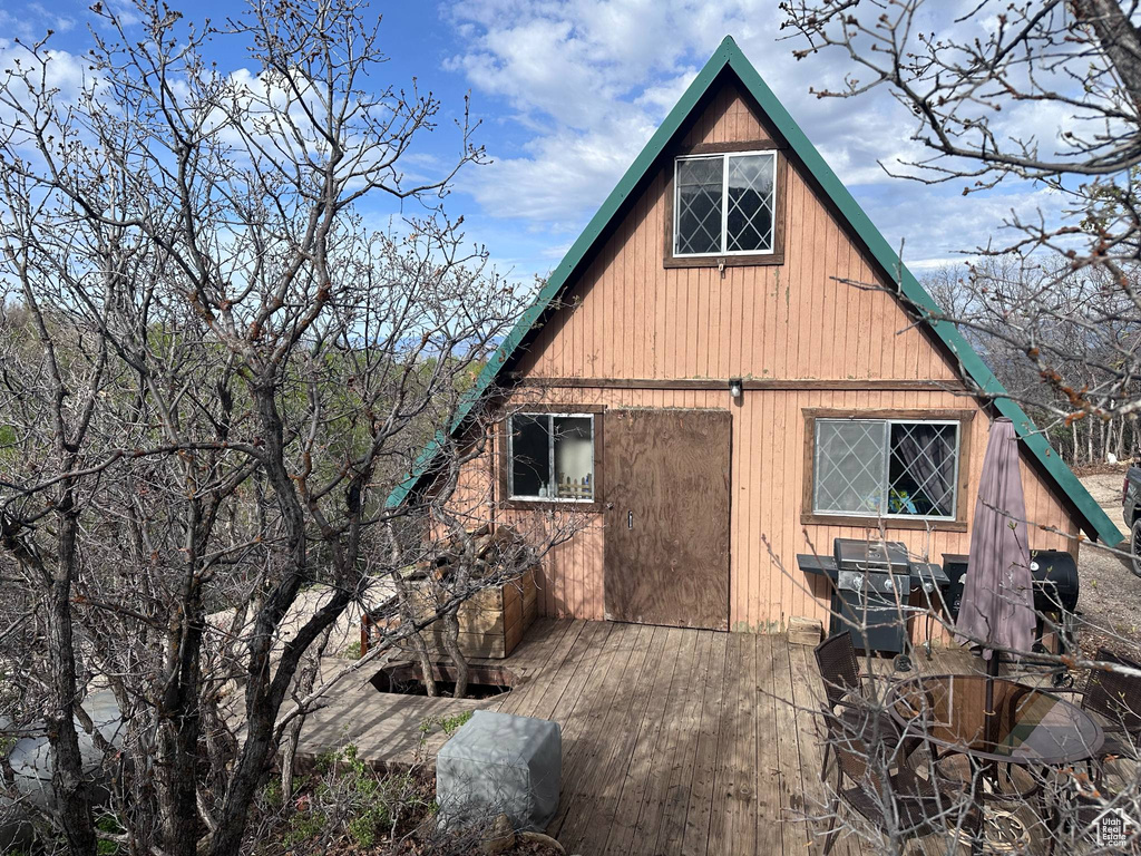 Back of house with a wooden deck