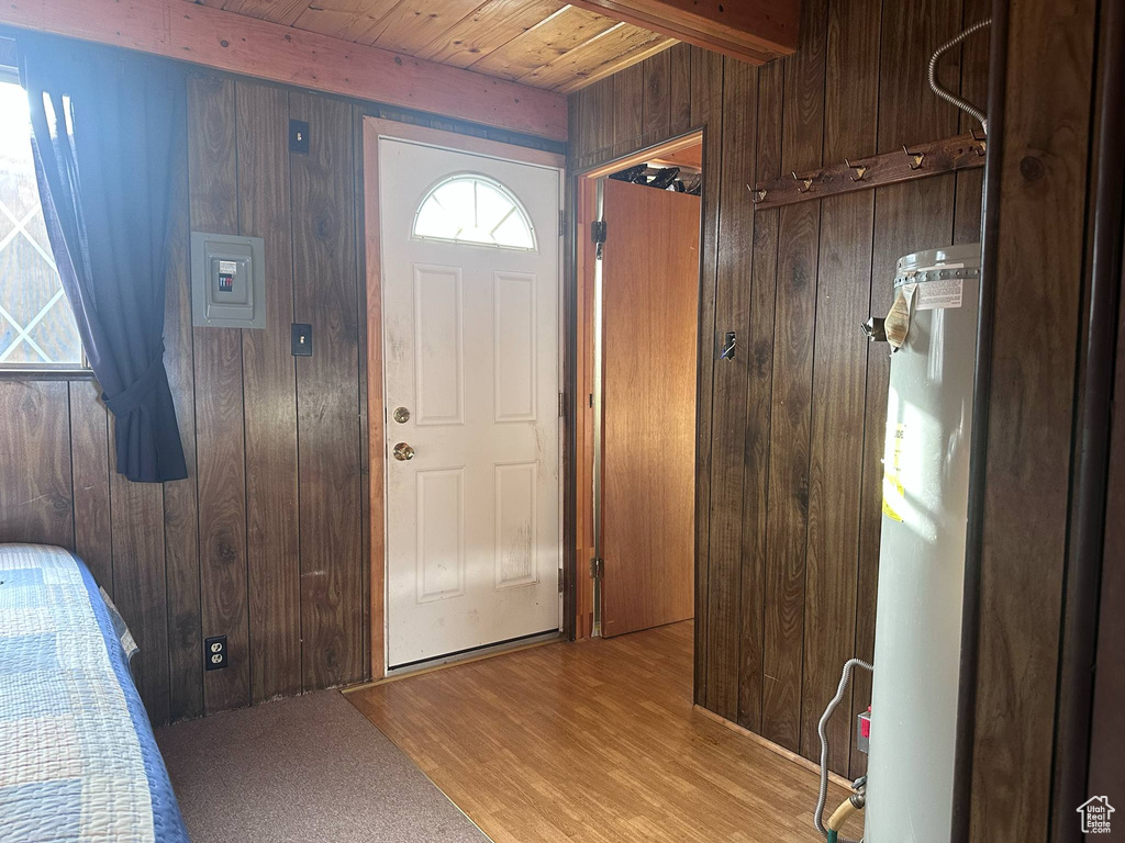 Entryway featuring wood walls, wood ceiling with exposed beams, and wood finished floors