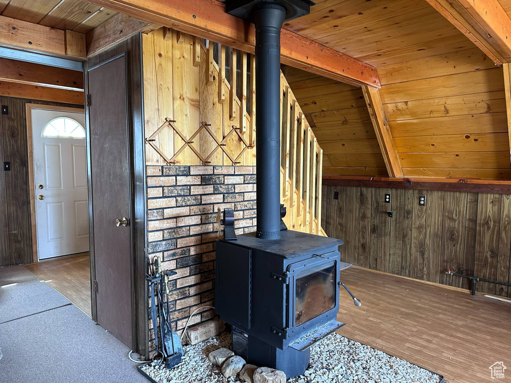 Detailed view of a wood stove, wooden walls, and wood finished floors