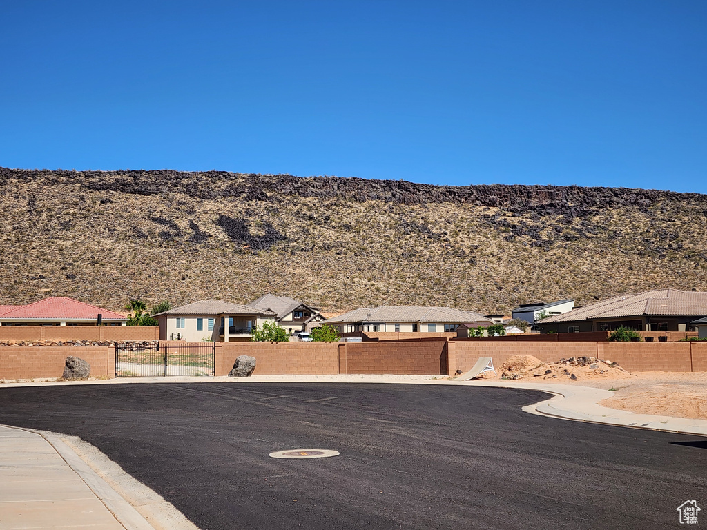 View of asphalt street with a mountain view, curbs, and a residential view