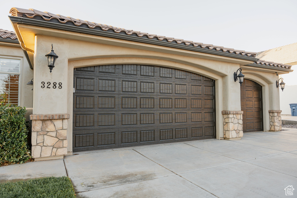 Garage featuring concrete driveway