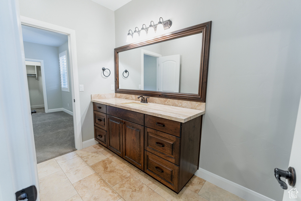 Bathroom featuring vanity and baseboards