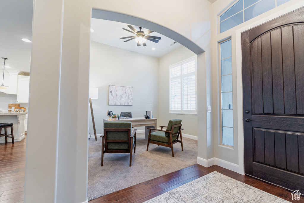 Entrance foyer featuring dark wood-type flooring, ceiling fan, arched walkways, baseboards, and recessed lighting