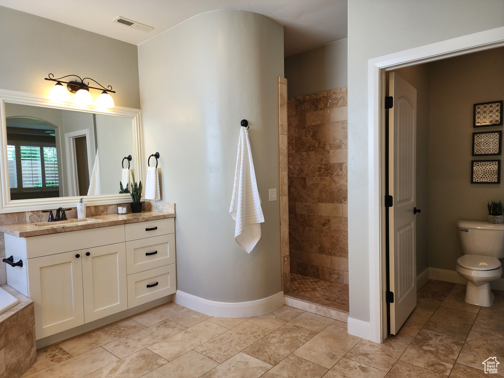 Bathroom featuring vanity, walk in shower, baseboards, and toilet