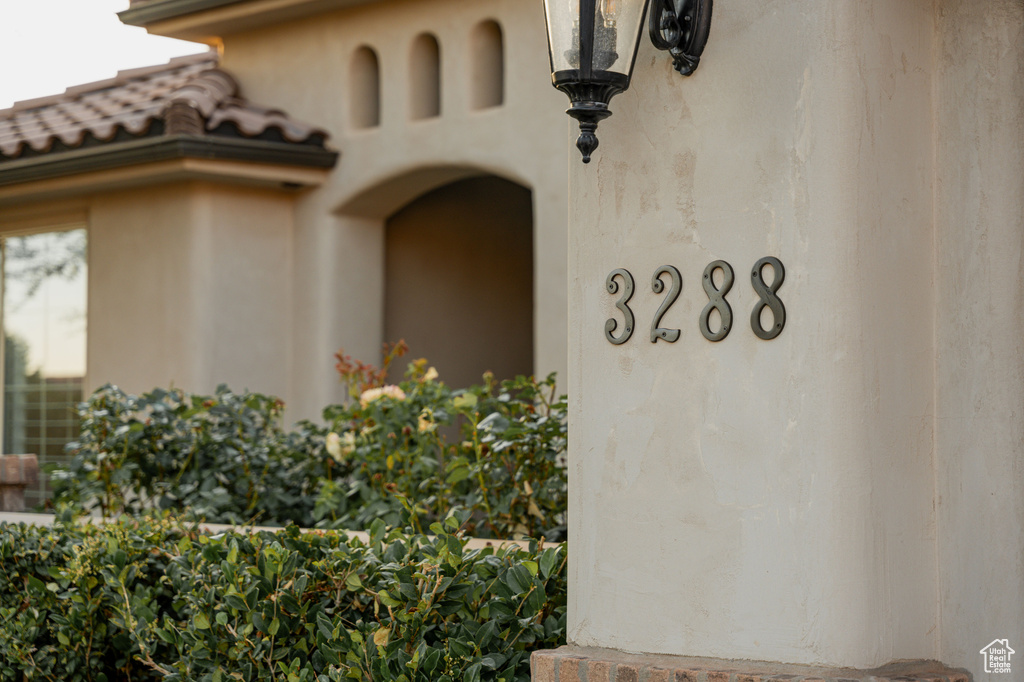 Property entrance with a tile roof and stucco siding