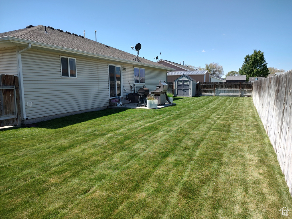 Back of house with a patio and roof with shingles