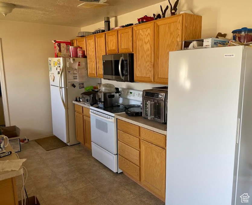 Kitchen with white appliances and light countertops
