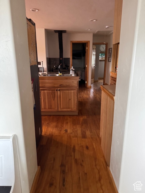 Kitchen featuring wood-type flooring and a sink
