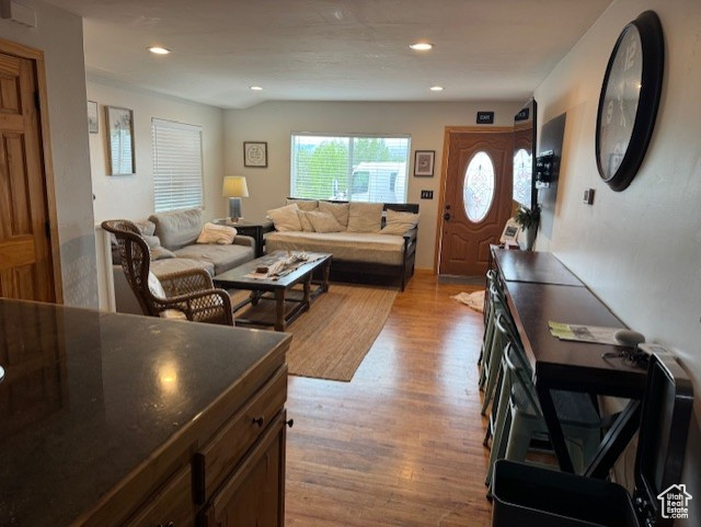 Living room featuring light wood-type flooring and recessed lighting