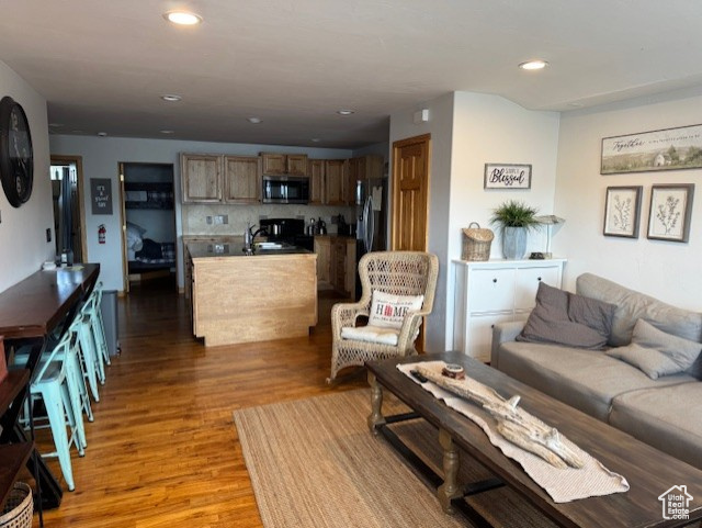 Living area featuring light wood-style floors and recessed lighting