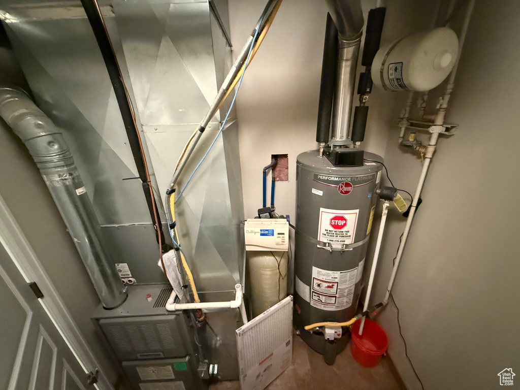 Utility room with water heater and heating unit