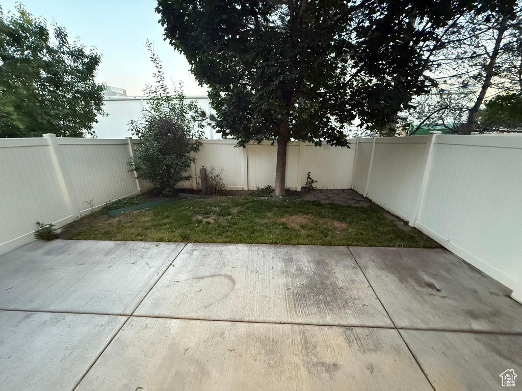 Fenced backyard featuring a patio