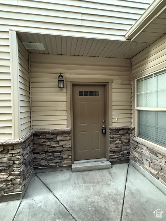 Property entrance with stone siding