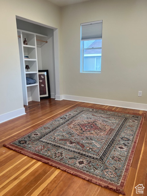 Bedroom with wood finished floors and baseboards