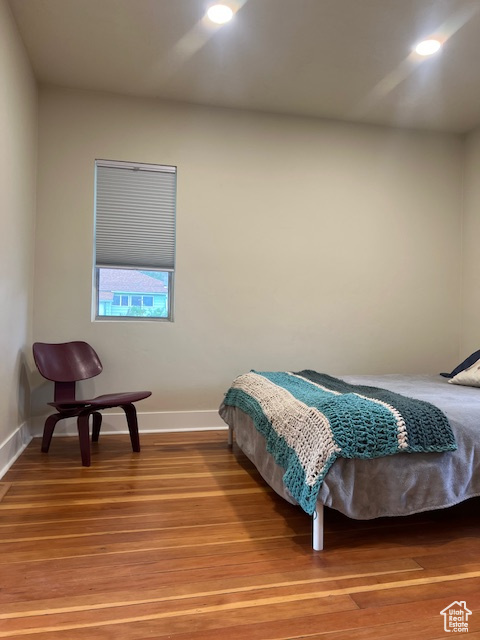 Bedroom with baseboards, light wood-style floors, and recessed lighting
