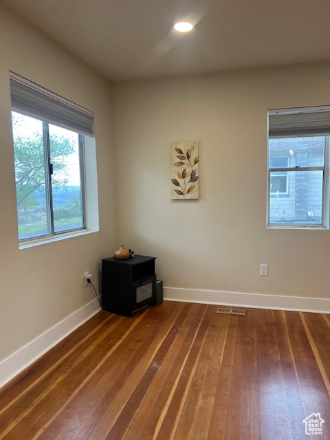 Spare room with hardwood / wood-style flooring and baseboards
