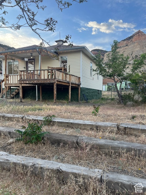 Back of property with a deck with mountain view