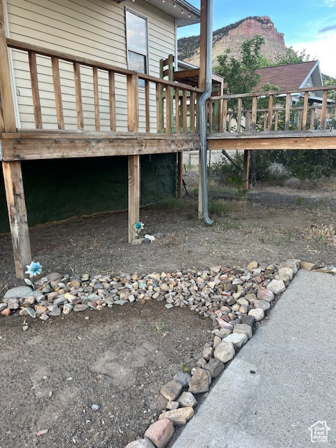 View of side of property featuring a deck with mountain view