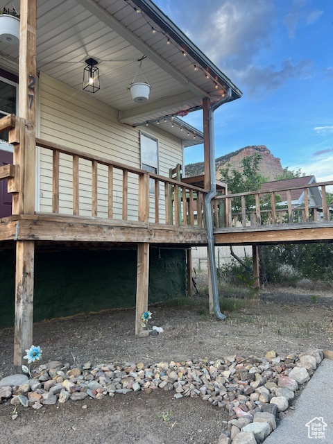 View of property exterior with a deck with mountain view