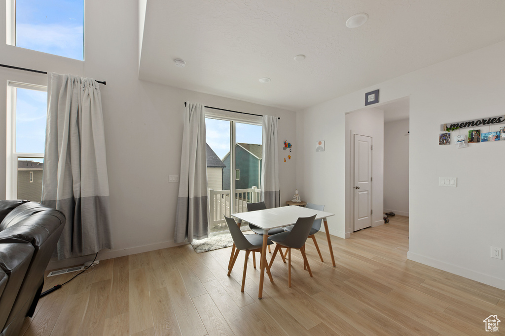 Dining space with light wood finished floors and baseboards