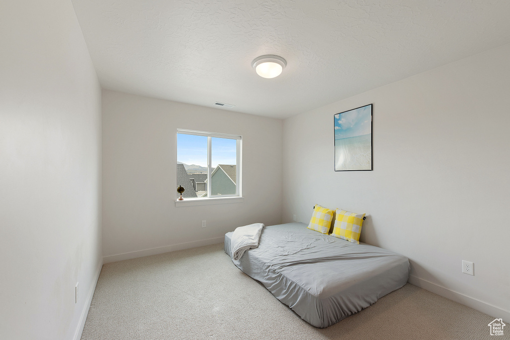 Bedroom featuring carpet flooring and baseboards