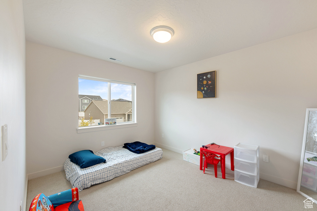 Carpeted bedroom featuring baseboards