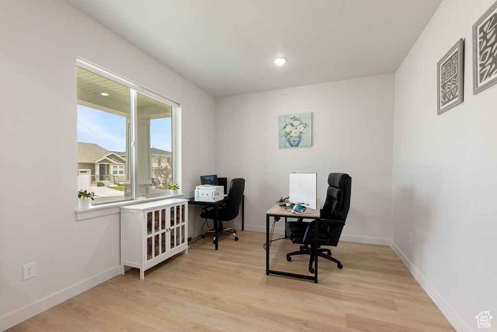 Office with light wood finished floors, baseboards, and recessed lighting