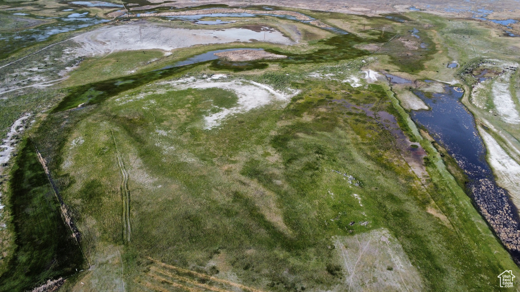 Aerial view of property and surrounding area featuring a nearby body of water
