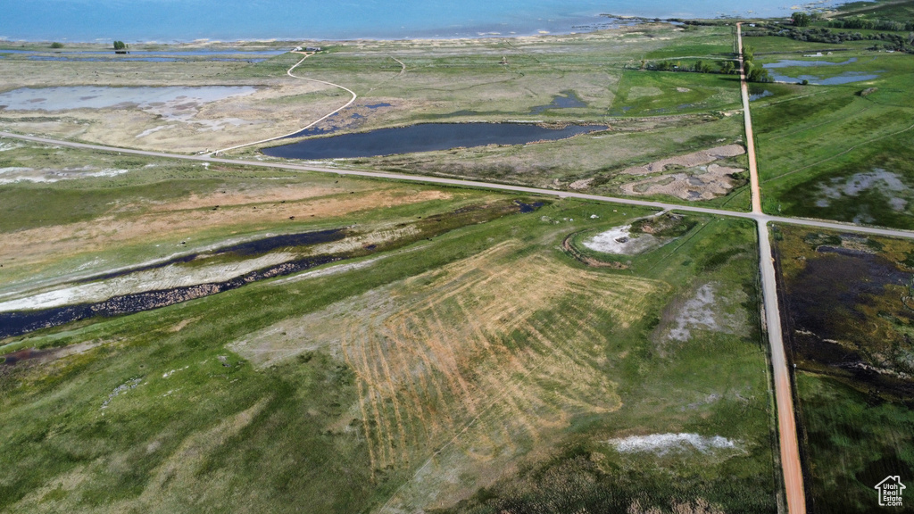 Aerial view of property and surrounding area featuring a large body of water