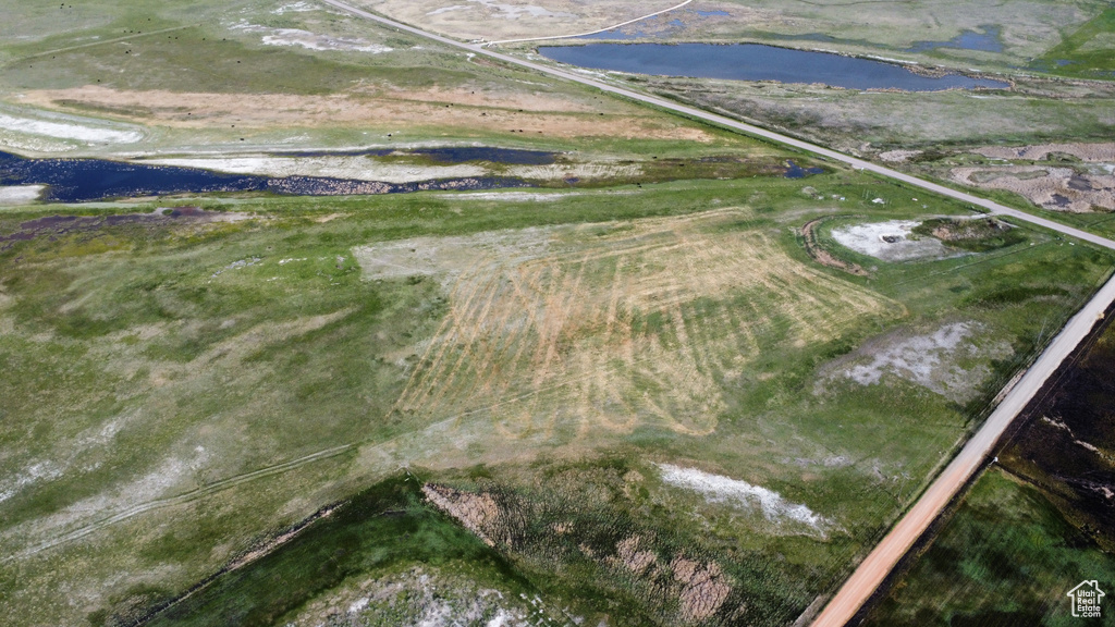 Aerial view of property and surrounding area featuring a large body of water