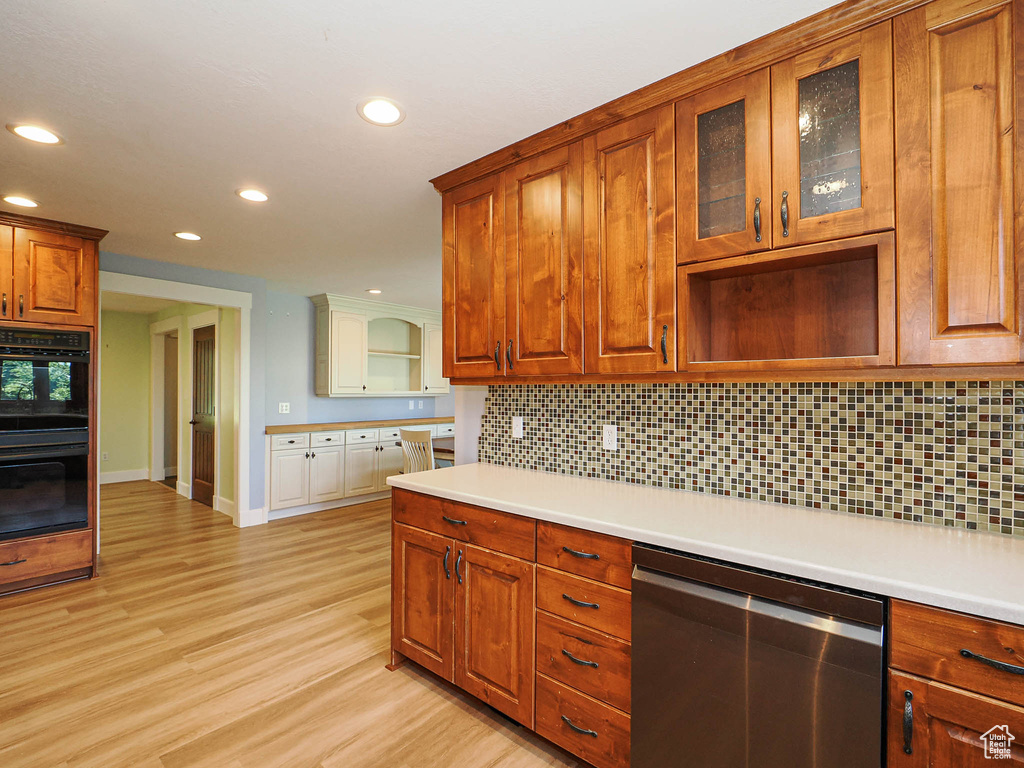 Kitchen featuring stainless steel dishwasher, recessed lighting, open shelves, light wood-style floors, and backsplash