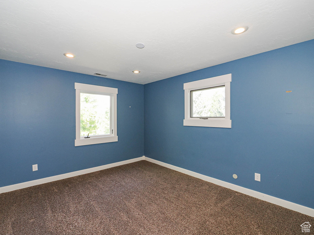 Unfurnished room with plenty of natural light, baseboards, carpet floors, and recessed lighting