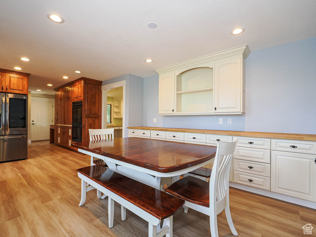 Dining area featuring light wood-style floors and recessed lighting